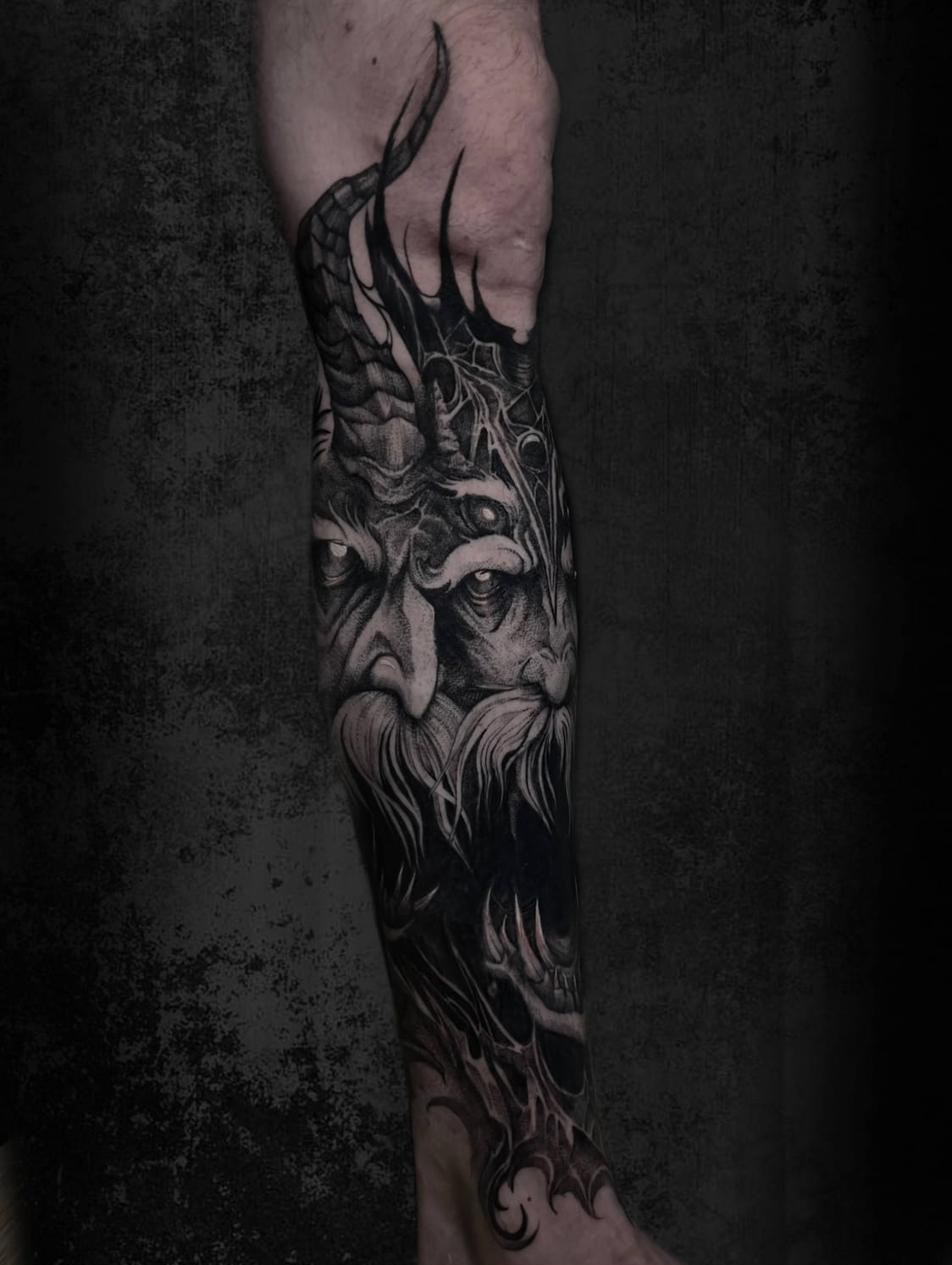Dark fantasy tattoo artist Uppsala — demon face close-up, lower leg