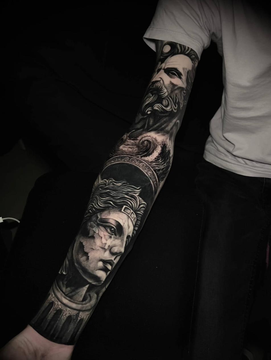 Tattoo artist Uppsala Tim Blackhands — mythological full sleeve with Poseidon and statue