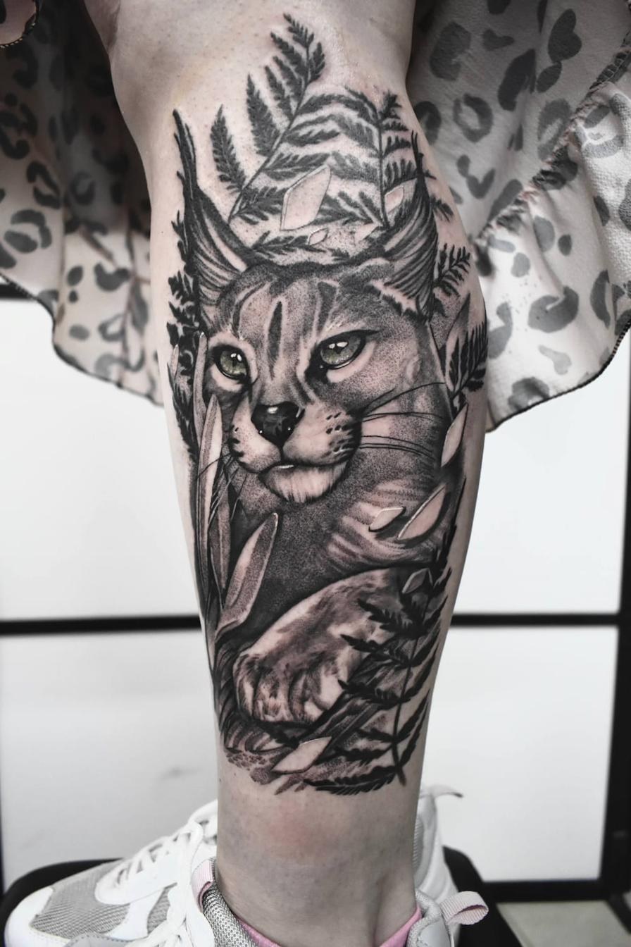 Realistic tattoo Uppsala — lynx in nature motif, calf